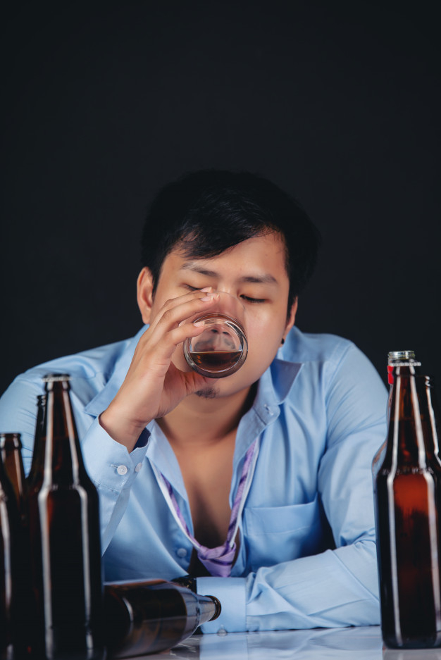 Alcoholic asian man drinking whisky with a lot of bottles Free Photo -  Nohat - Free for designer